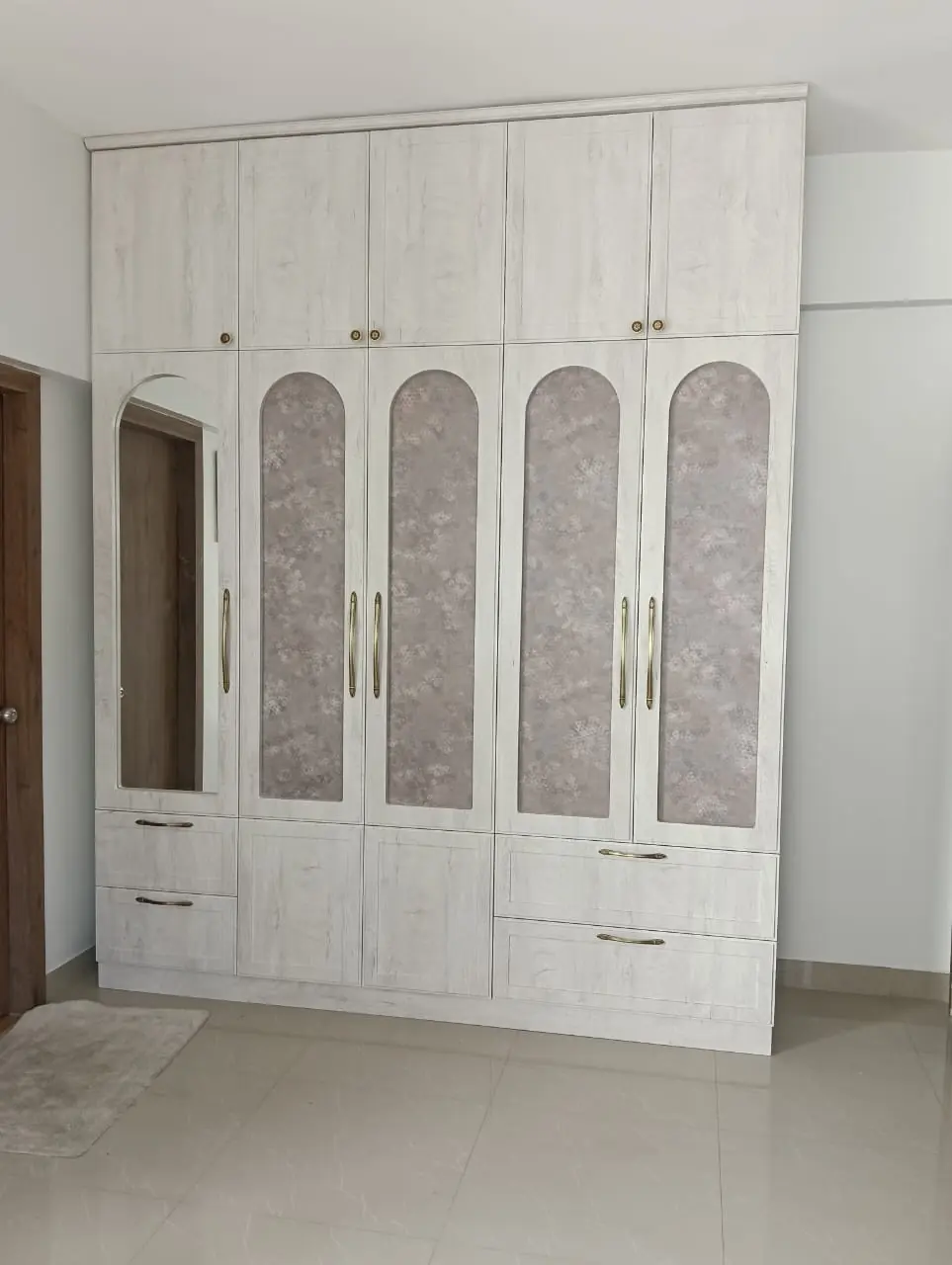European-style wardrobe with arched fabric panels, mirror and brass handles, Pune