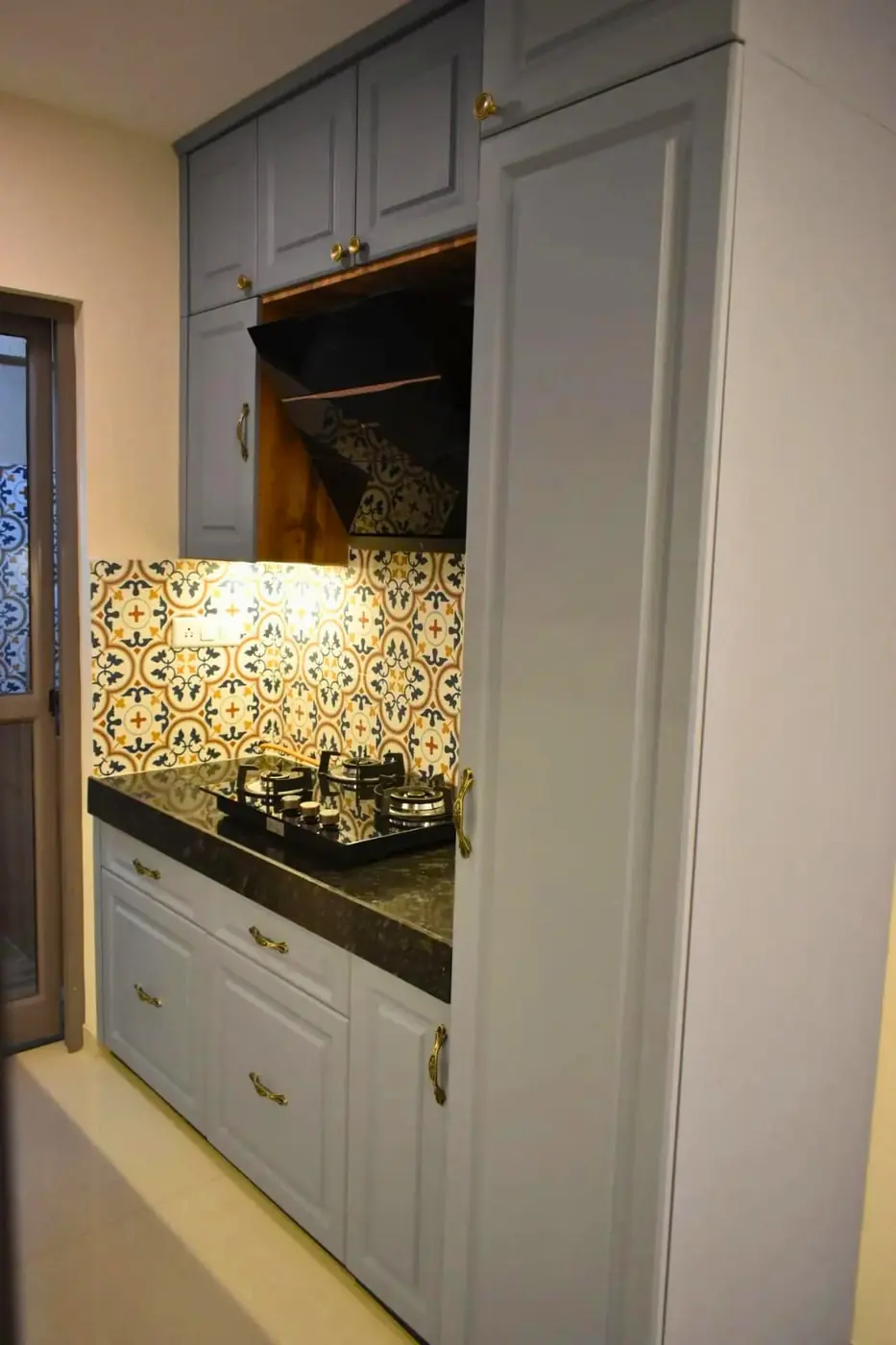 Grey modular kitchen with floor-to-ceiling tall storage unit, Pune